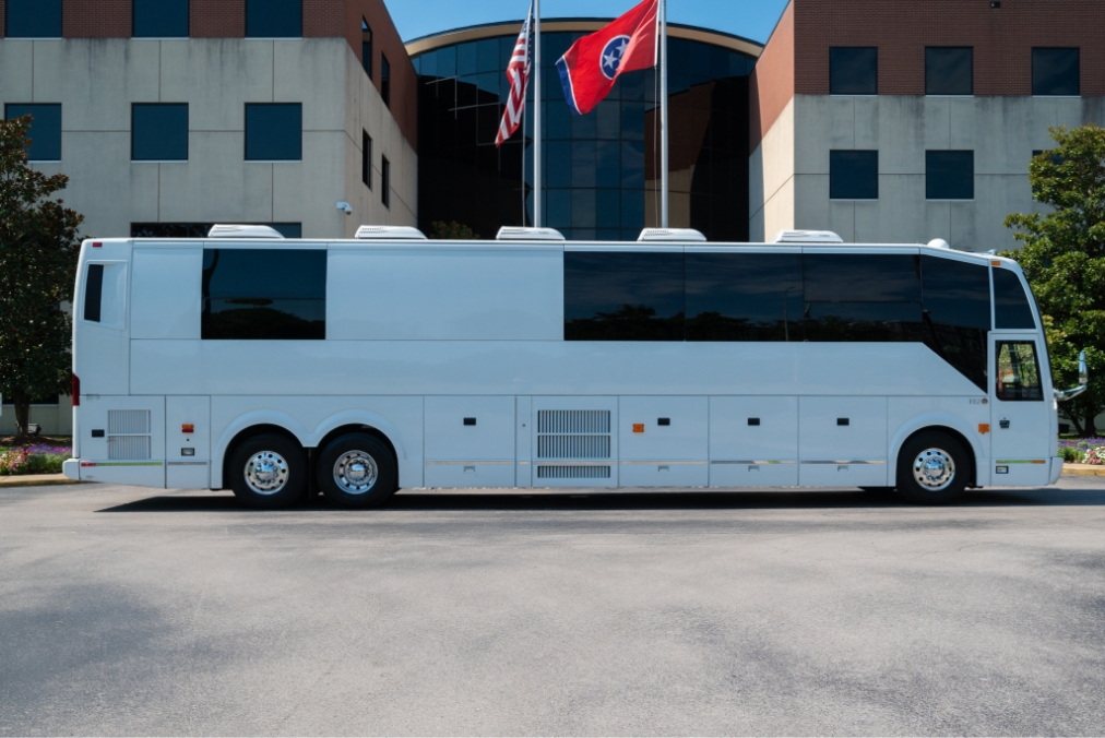 Side view of a Prevost H345 bus conversion for sale, highlighting the sleek design of this entertainer bus, perfect for tours and luxury travel.