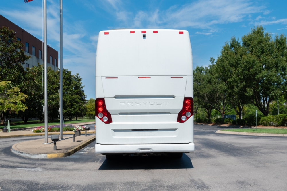 Direct rear view of a Prevost H345 bus conversion, showcasing the rear design and storage capacity, ideal for an entertainer bus.