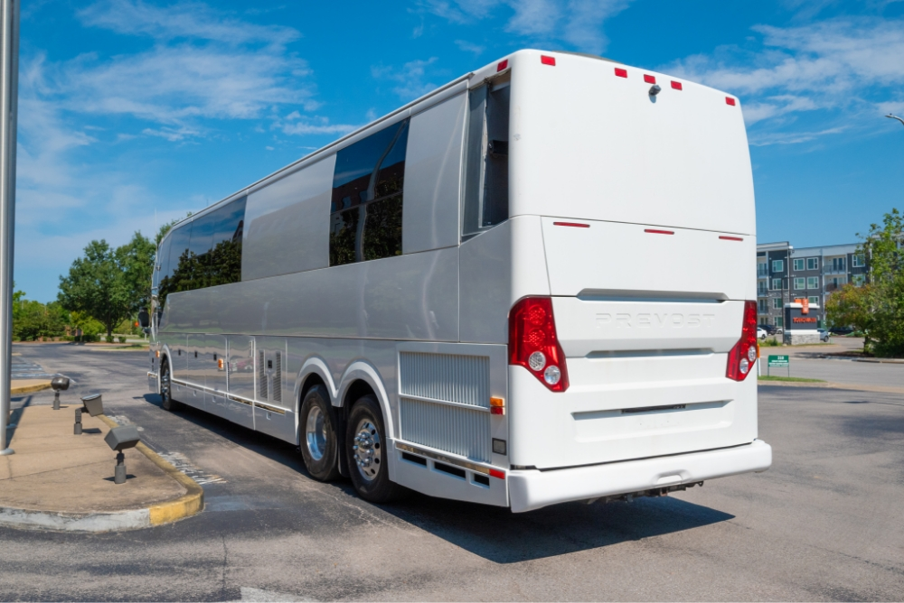 Rear side view of a Prevost H345 entertainer bus for sale, showing the modern design and exterior finish, ideal for bus conversions and long-distance travel.
