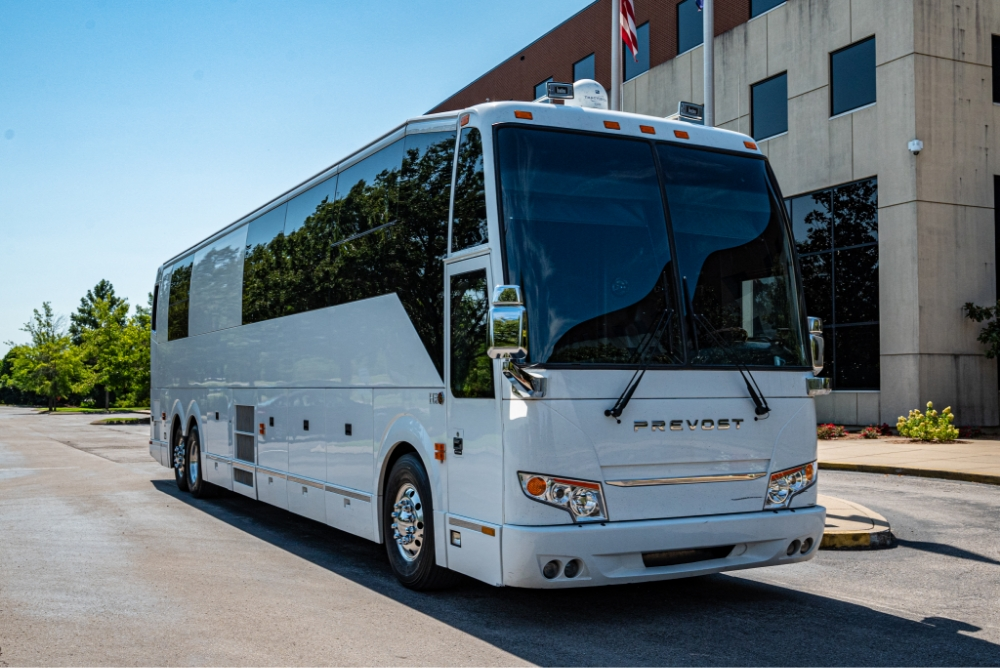 Side view of a Prevost H345 bus conversion for sale, offering a spacious, luxury entertainer bus designed for comfort and efficiency.