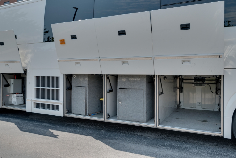 Close-up of open side storage compartments on a Prevost H345 entertainer bus for sale, highlighting easy-access storage for long-distance travel.