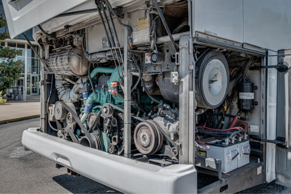 Engine and mechanical systems of a Prevost H345 bus conversion for sale, emphasizing its powerful and reliable setup for entertainer bus use.