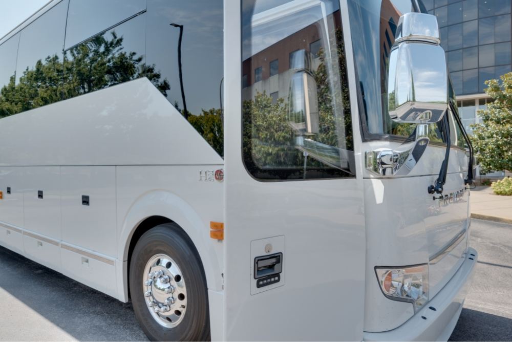 Close-up of the front side of a Prevost H345 bus, highlighting the sleek exterior design and modern styling for entertainment and travel use.