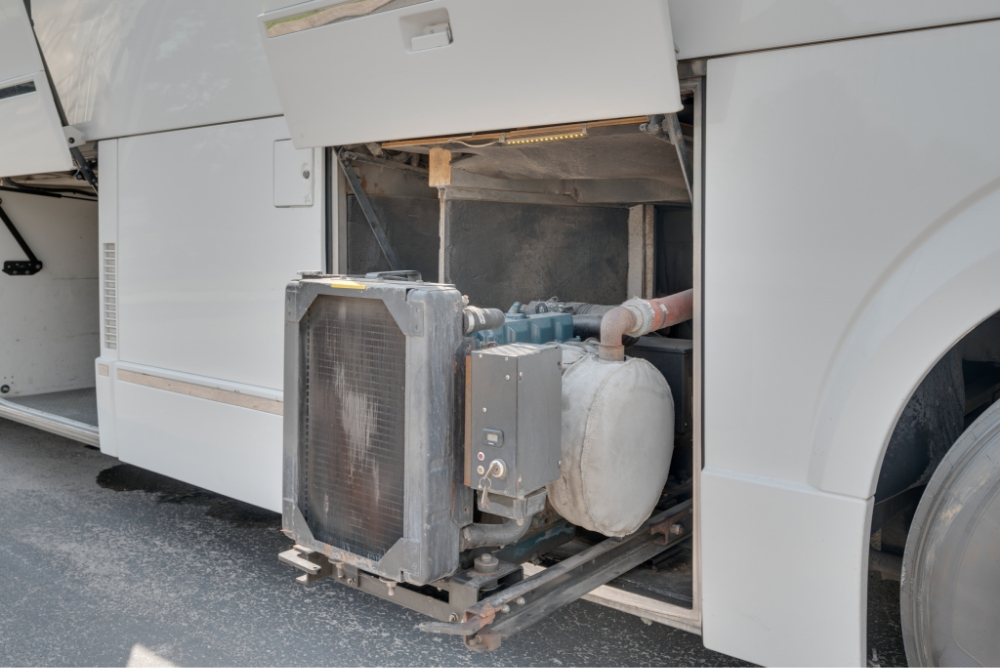 Side view of an open compartment housing equipment in a Prevost H345 bus, illustrating the organized setup for efficient maintenance.