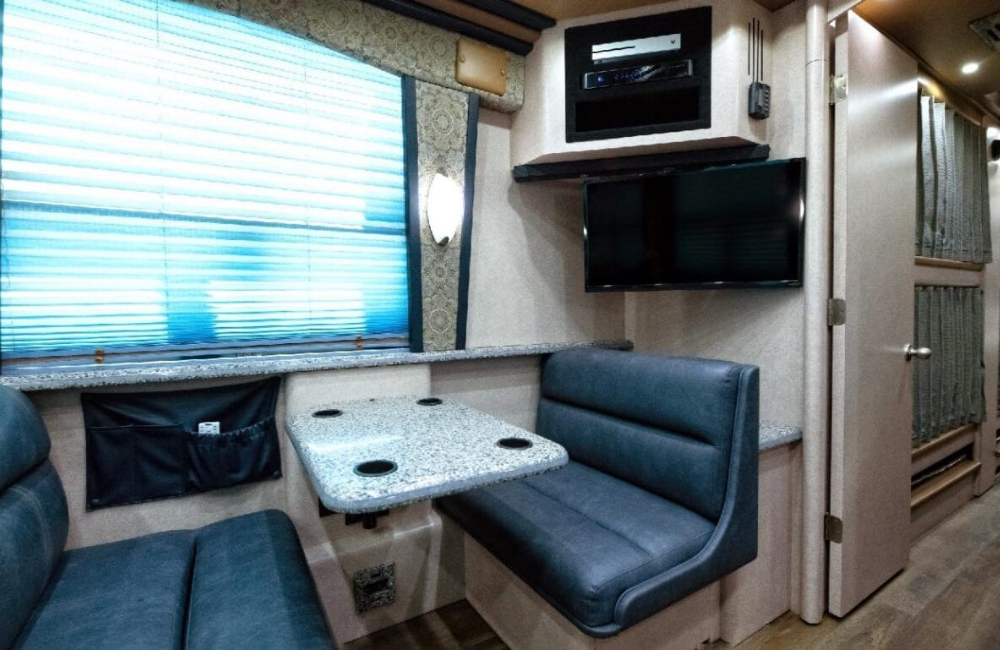 Interior dining and kitchen space in the 2007 Prevost XLII with a comfortable, stylish design