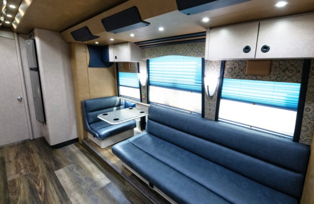 Dining and seating area inside the bus, highlighting spacious comfort and a modern aesthetic