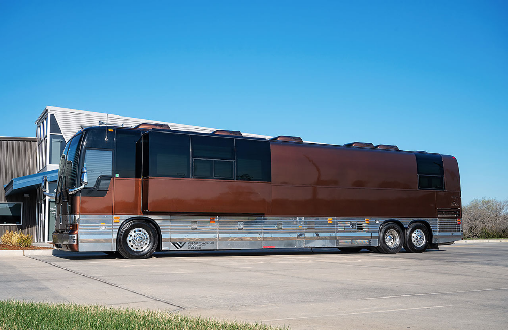 Exterior side view of a 2007 Prevost XLII bus conversion, featuring a sleek brown and silver design