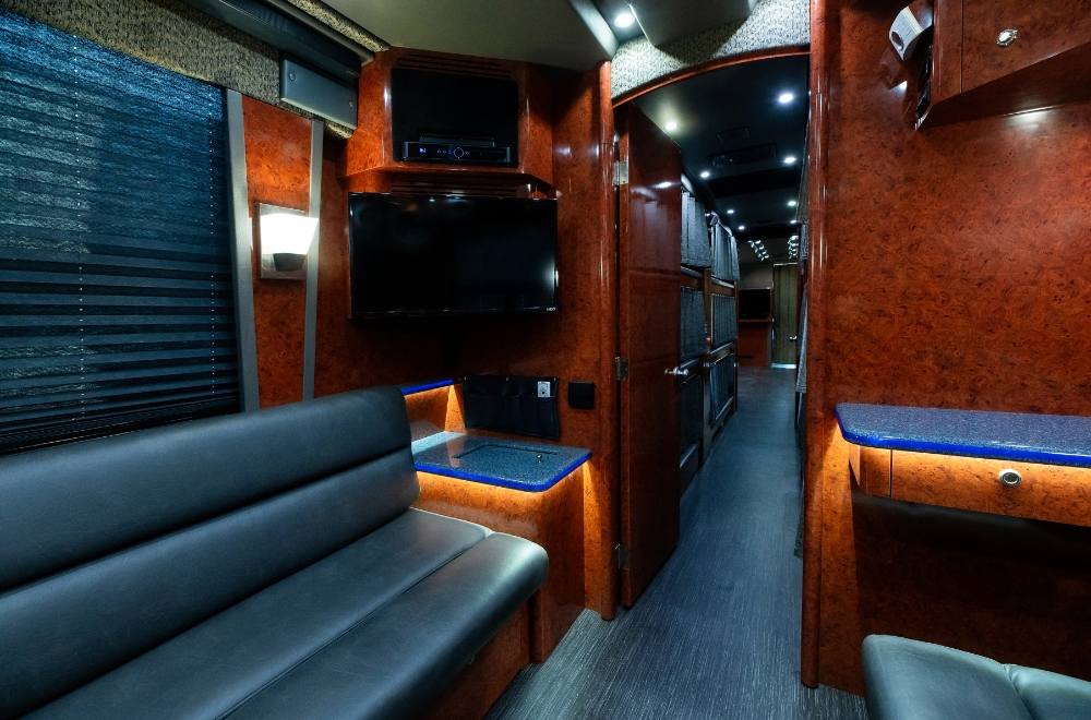 Spacious lounge area inside a 2006 Prevost XLII bus conversion for sale, featuring comfortable seating for travel and entertainment purposes.