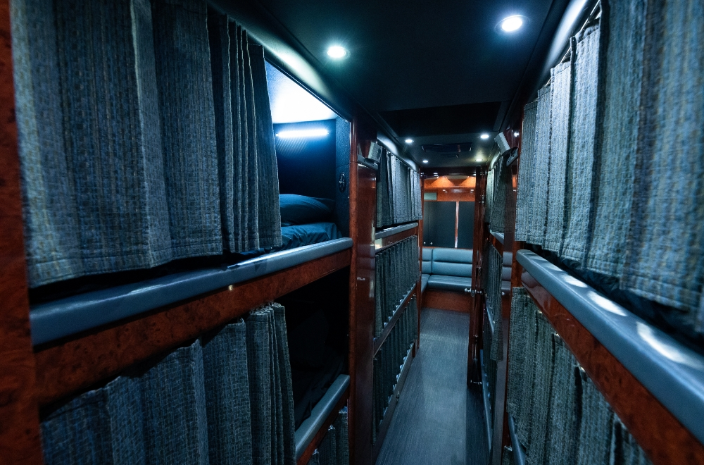 Hallway in the 2006 Prevost XLII Entertainer bus conversion leading to sleeping bunks, offering comfort and privacy for overnight travel.