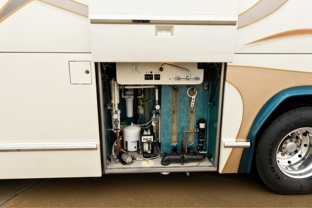 Utility compartment on the side of a 2000 Prevost H345 motorhome for sale, showcasing accessible storage for mechanical systems and utilities.