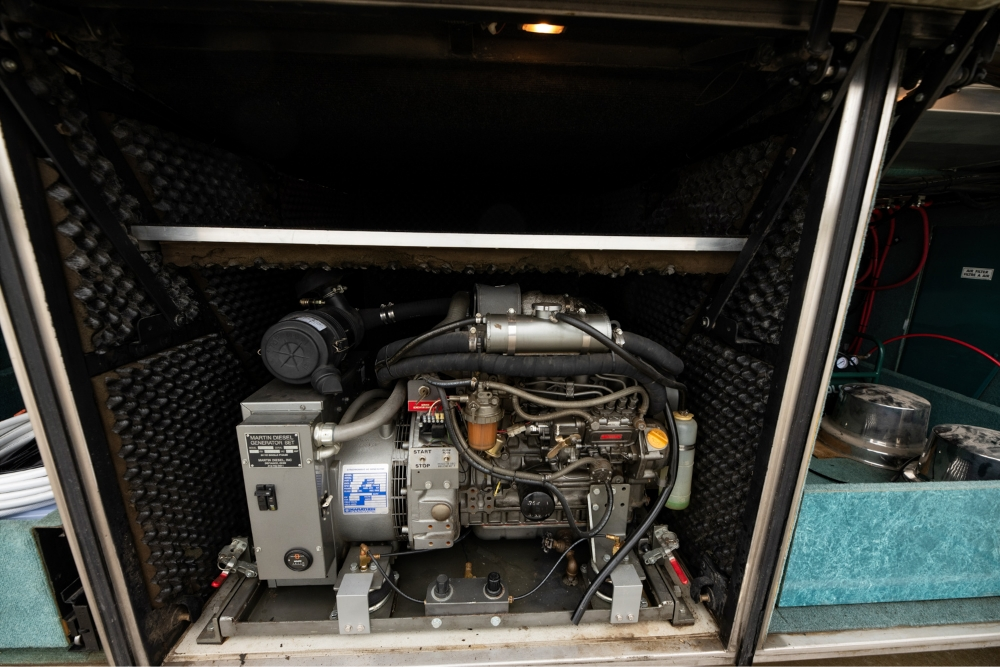 Open engine and mechanical compartment of a 2000 Prevost H345 bus conversion for sale, featuring a well-maintained engine for reliable performance.