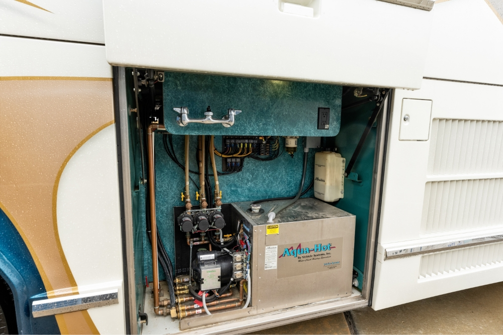 View of the electrical and utility systems in a 2000 Prevost H345 motorhome for sale, highlighting organized compartments for easy access and maintenance.