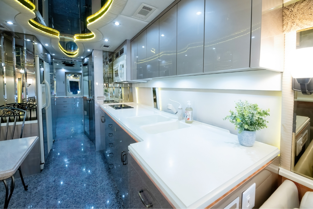 Interior hallway of a 2000 Prevost H345 motorhome, leading to the spacious kitchen and bathroom, designed for executive travel and comfort.