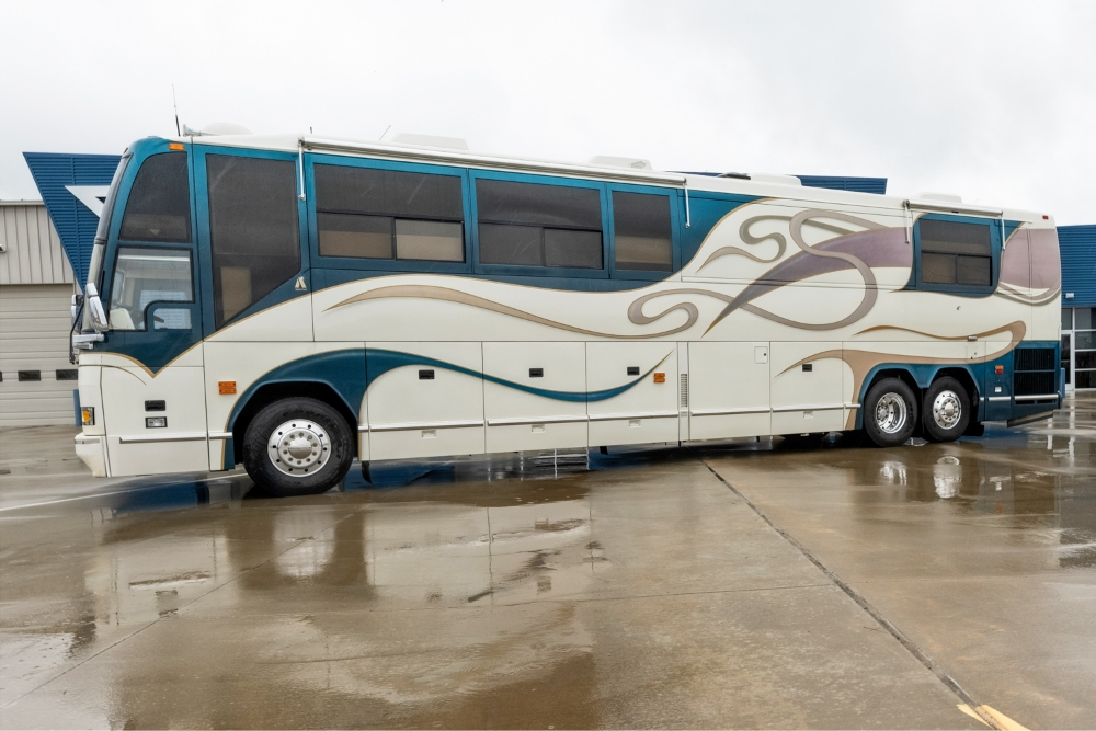 Side view of a used Prevost bus for sale showcasing its exterior features.