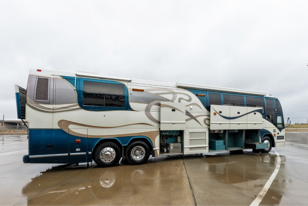 Full side view of a 2000 Prevost H345 bus conversion, showcasing the spacious and luxurious design of this motorhome for sale.