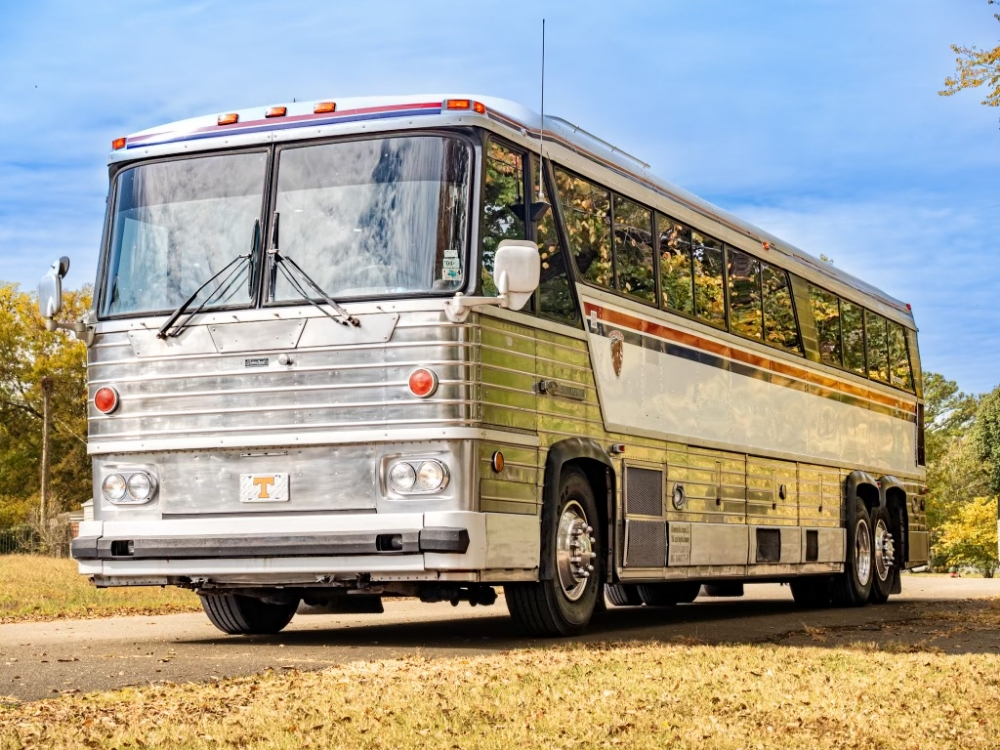 Front angled view of a 1976 MCI 8 Custom Coach Conversion for sale, featuring its classic design and polished exterior, ideal as an executive coach.