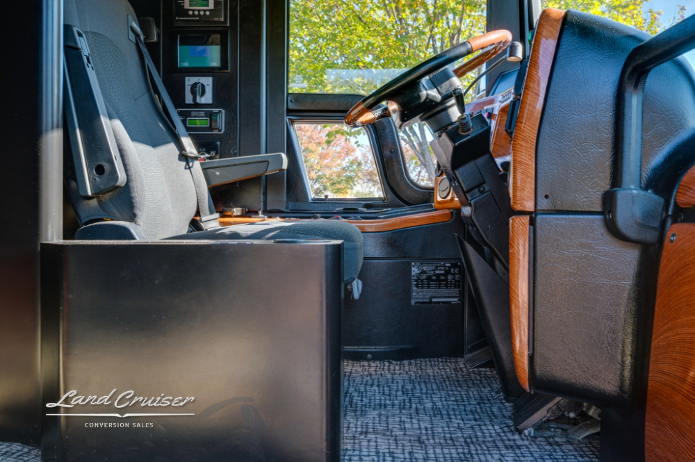 Driver's seat with wood accents in a 2006 Prevost bus conversion.
