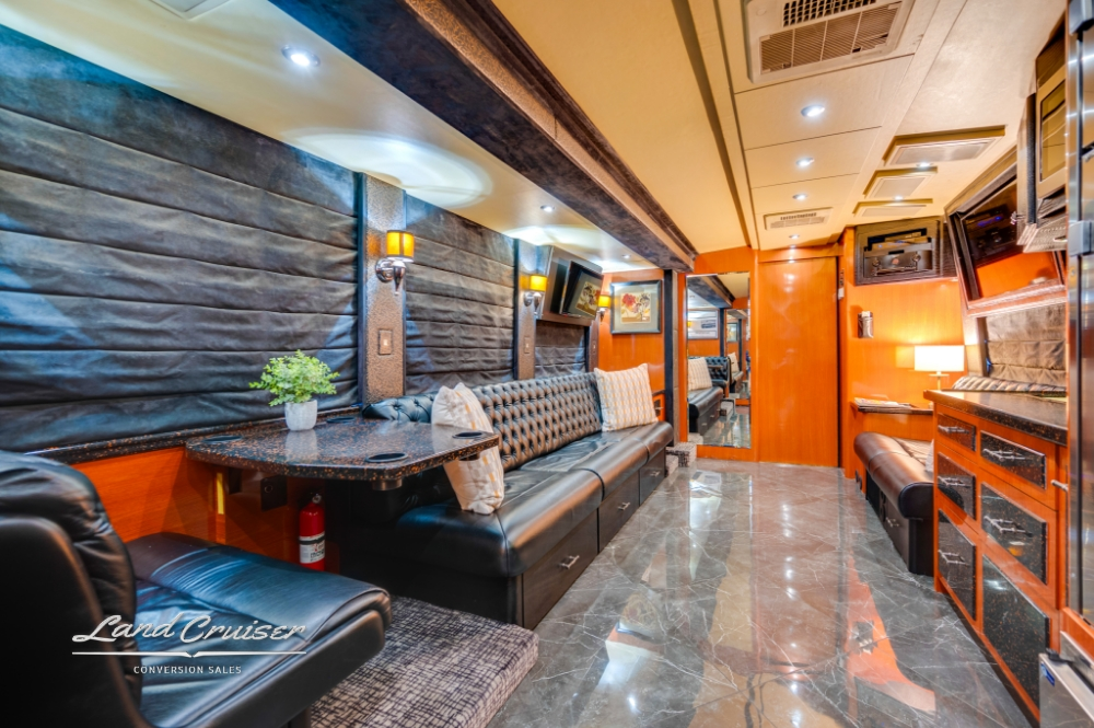 Dining booth with leather seating in 2006 Prevost entertainer bus.