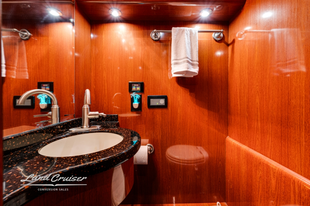 Vanity with beautiful wood walls in a prevost entertainer bus.