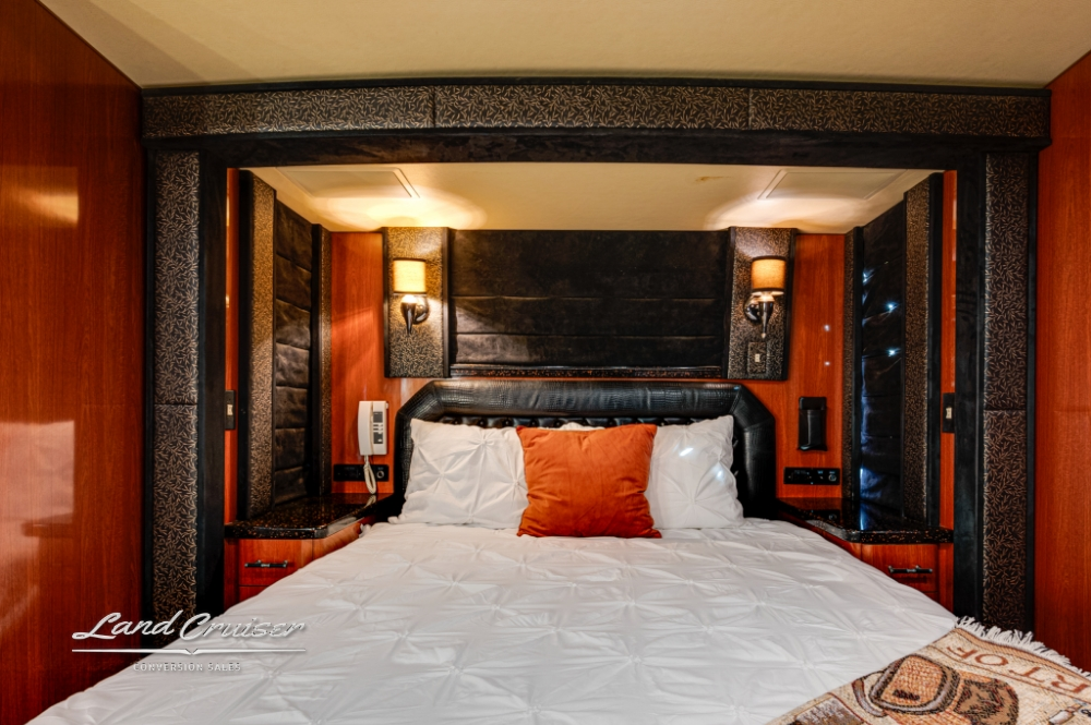 Spacious master bedroom in 2006 Prevost bus, with high-end decor.