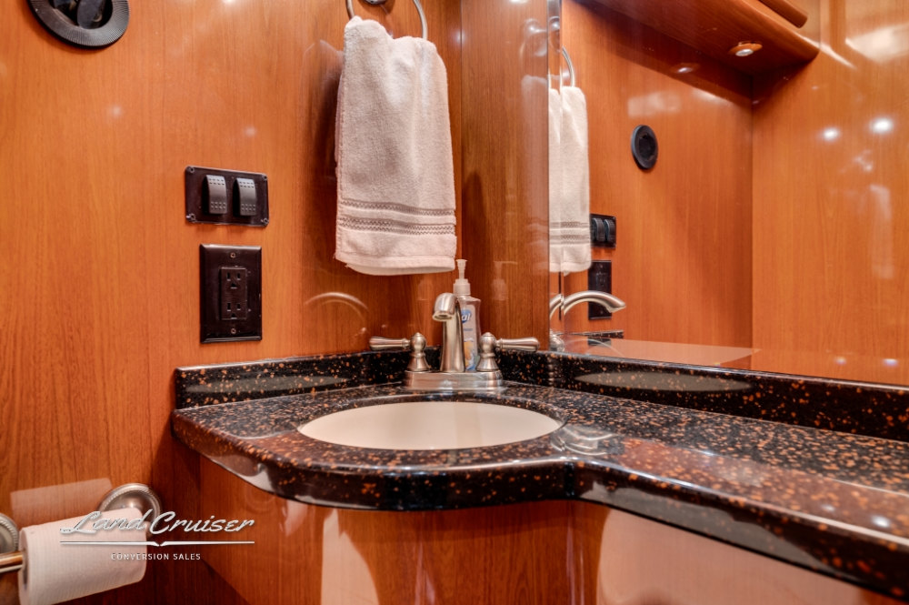 Luxury sink and vanity area in 2006 Prevost entertainer bus bathroom.