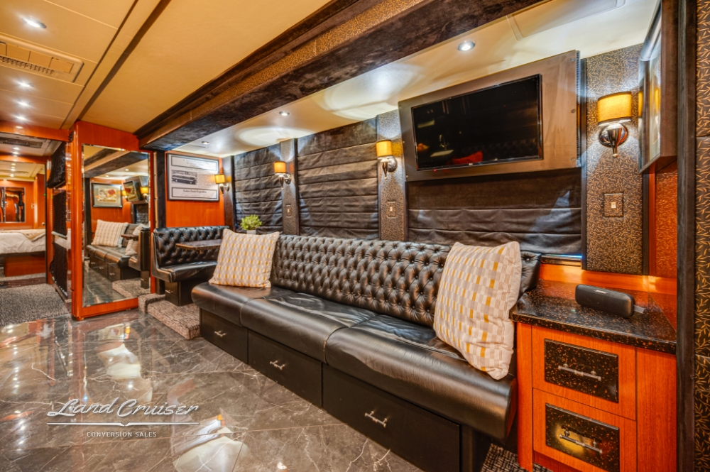 Spacious lounge with granite counters in Prevost tour bus, made for comfort.