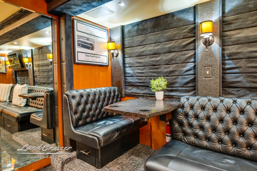 Dining booth with leather seating in 2006 Prevost entertainer bus.