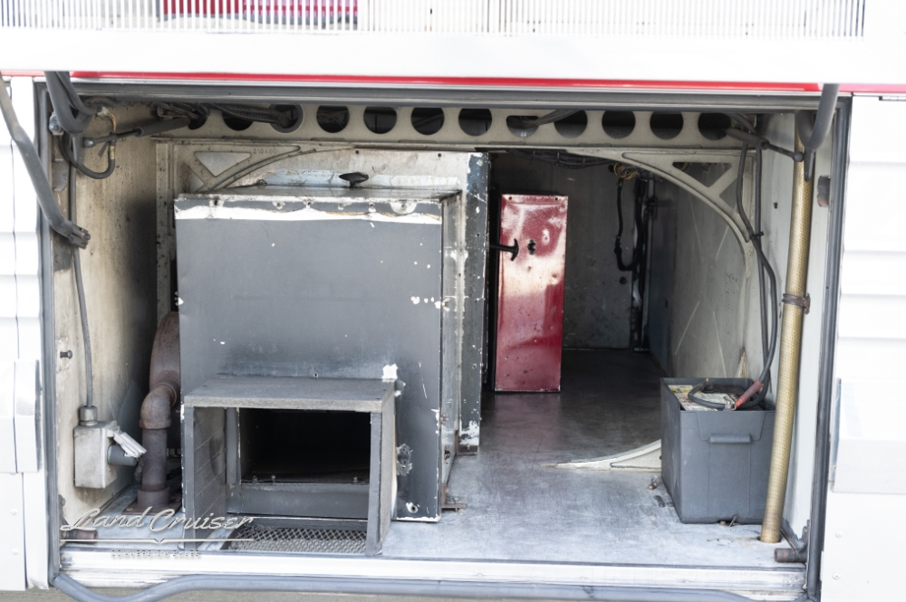Close up view of a compartment on a bus conversion for sale by landcruiser