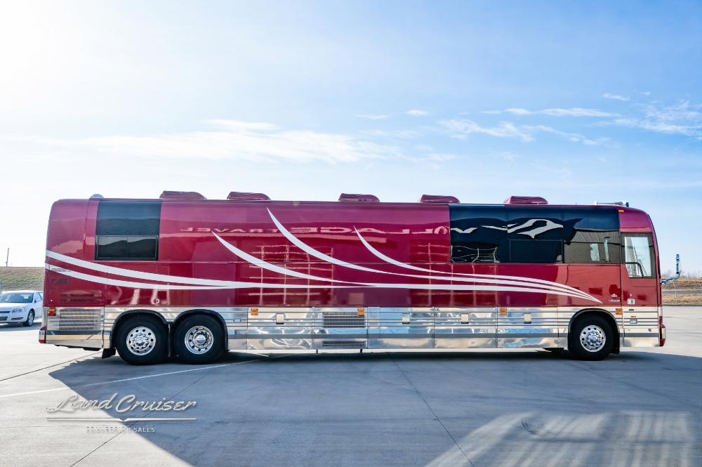Side view of a red entertainer bus for sale showcasing its white stripes on the side of the bus