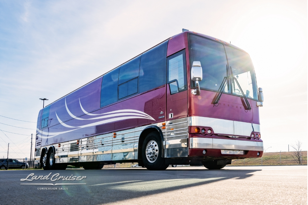 Front view with the bright sun showcasing this 2006 Prevost XLII bus for sale