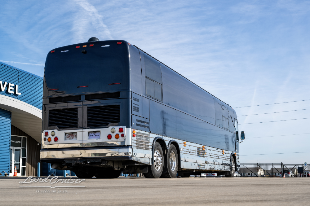 Back view of a motorcoach showcasing it's sleek black appearance