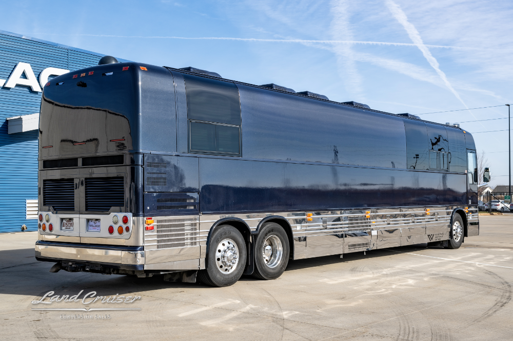 A side view of a sleek black entertainer bus for sale