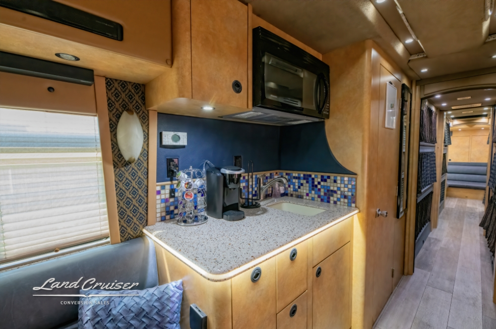 Another view of the kitchen showcasing the hardware, backsplash and counter of a 2007 Prevost