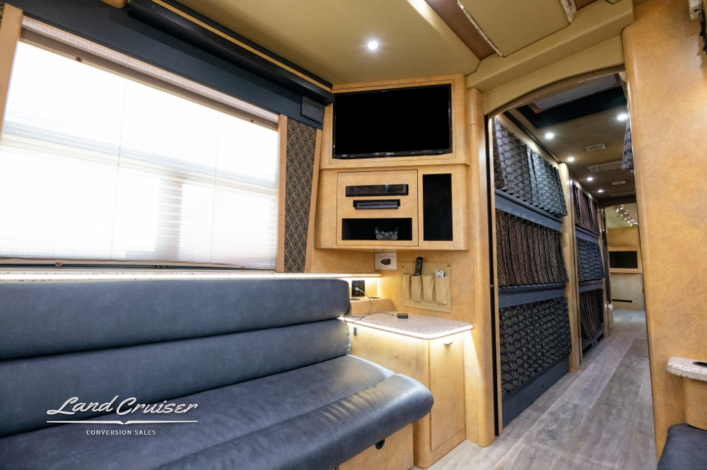 View of a tv, seating area and the bunks on this 2007 Custom Coach.