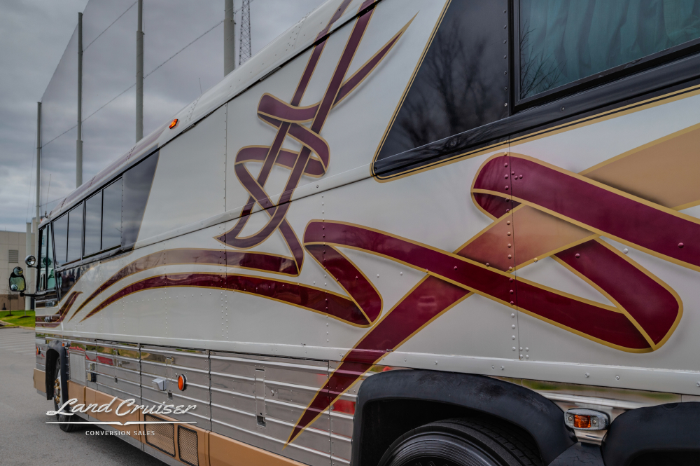Side angled view of stripes on a MCI conversion bus
