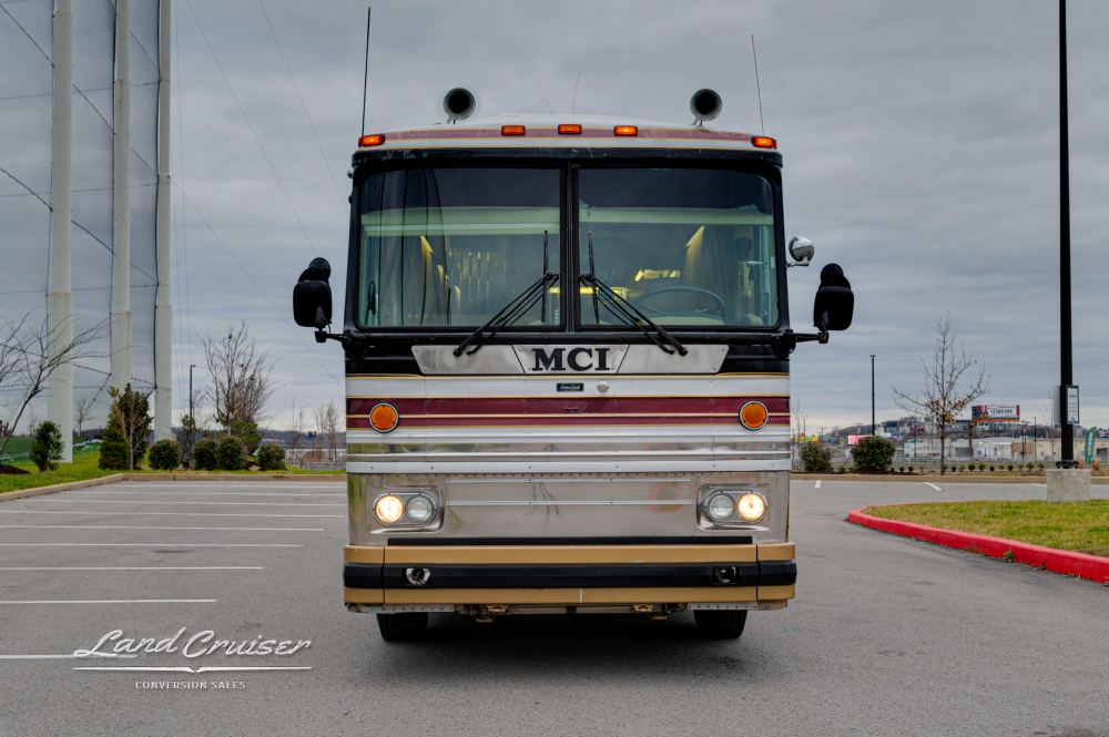 Front view of a custom coach parked in a parking lot
