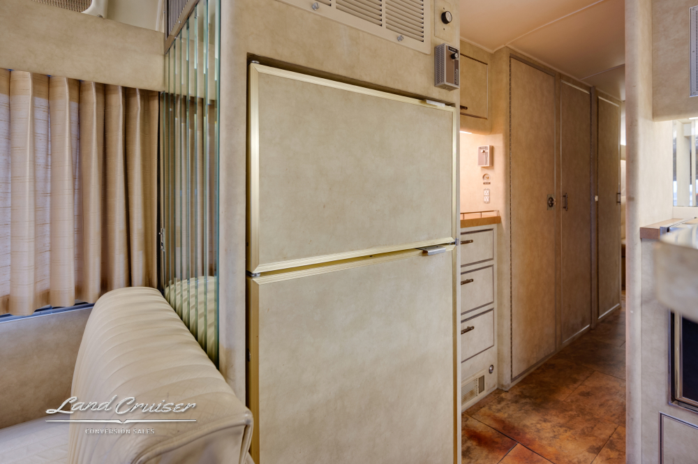 View of a fridge with a top mount freezer inside a 1978 Custom Coach