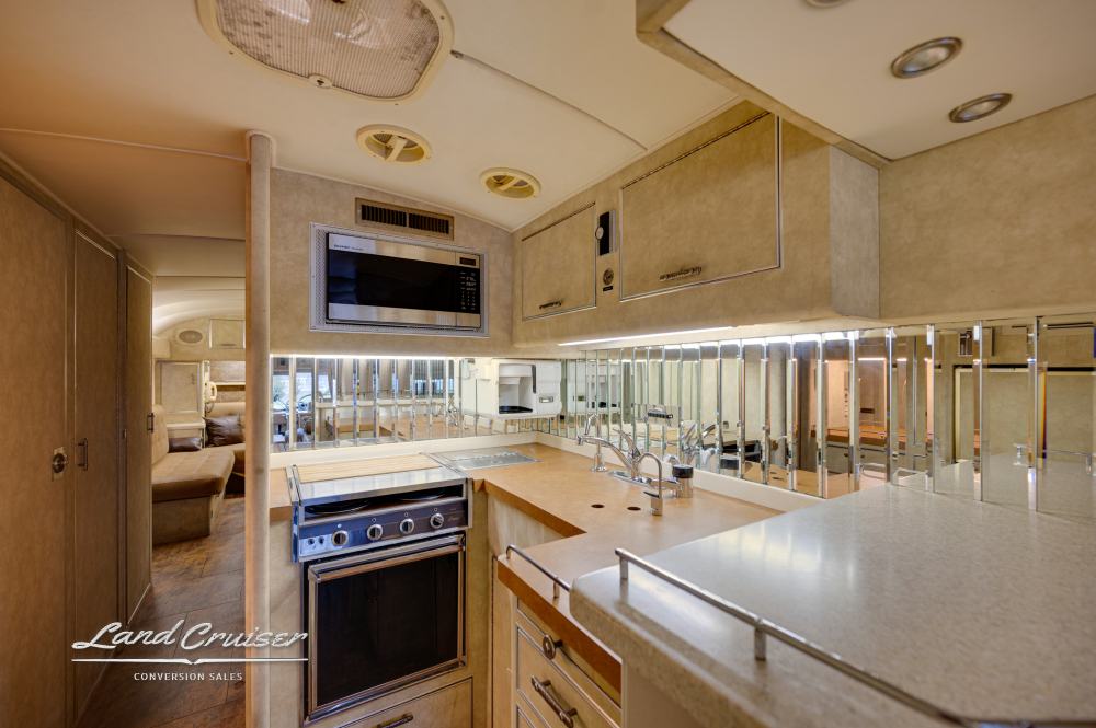 View of a motorcoach kitchen that is complete with a double sink and sink cover