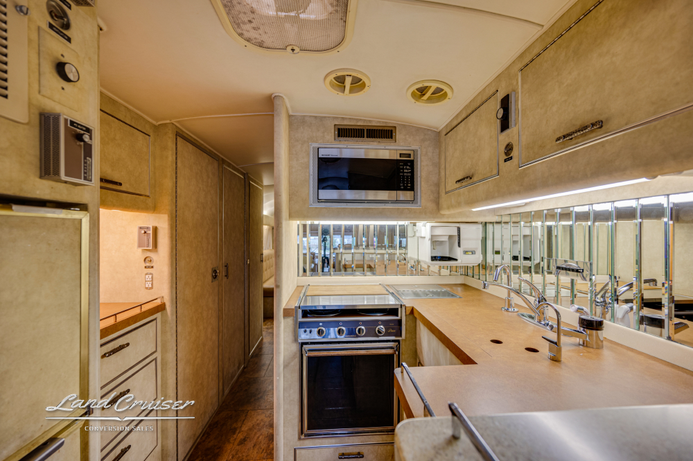 View of the kitchen with a hot water dispenser and a microwave oven