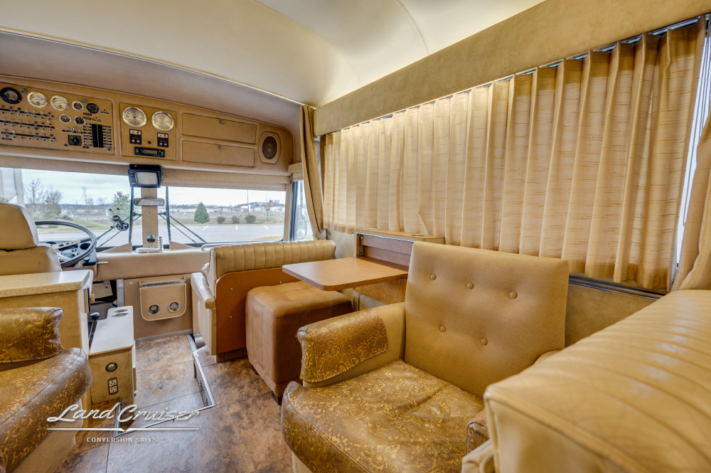 View of seating area with curtains inside a bus from 1978 that was converted