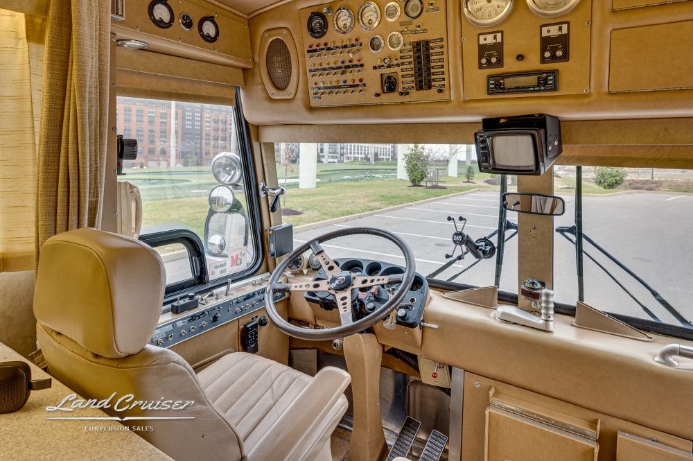 View of a drivers seat and area inside a MCI coach that was converted by Custom Coach Corporation