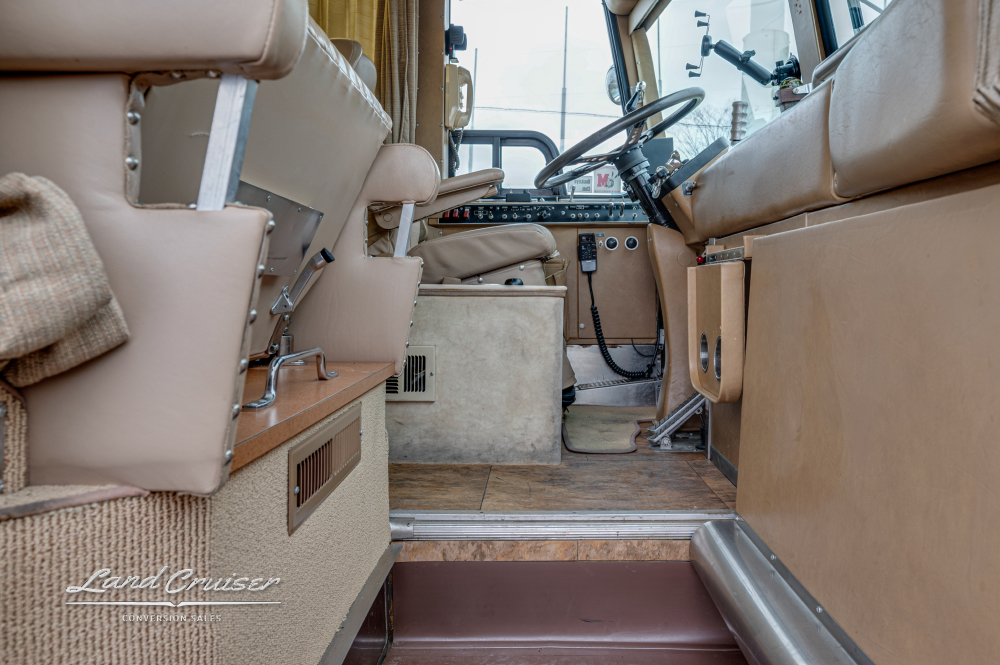 Interior view of the drivers area by the passenger seat of a MCI Bus