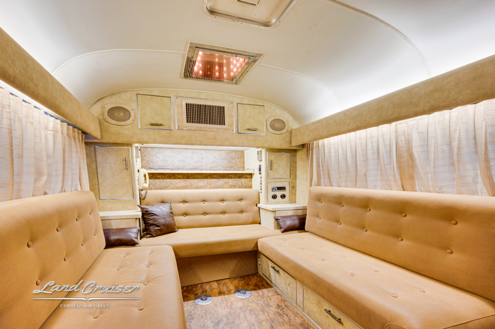 A view of lounge seating area showing that there's lots of room for people in this MCI bus