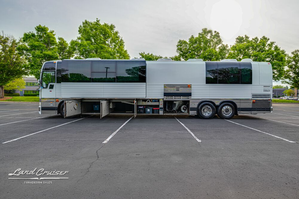 Full side view of 2004 Prevost XLII Shogun bus with extended super slide and polished stainless siding