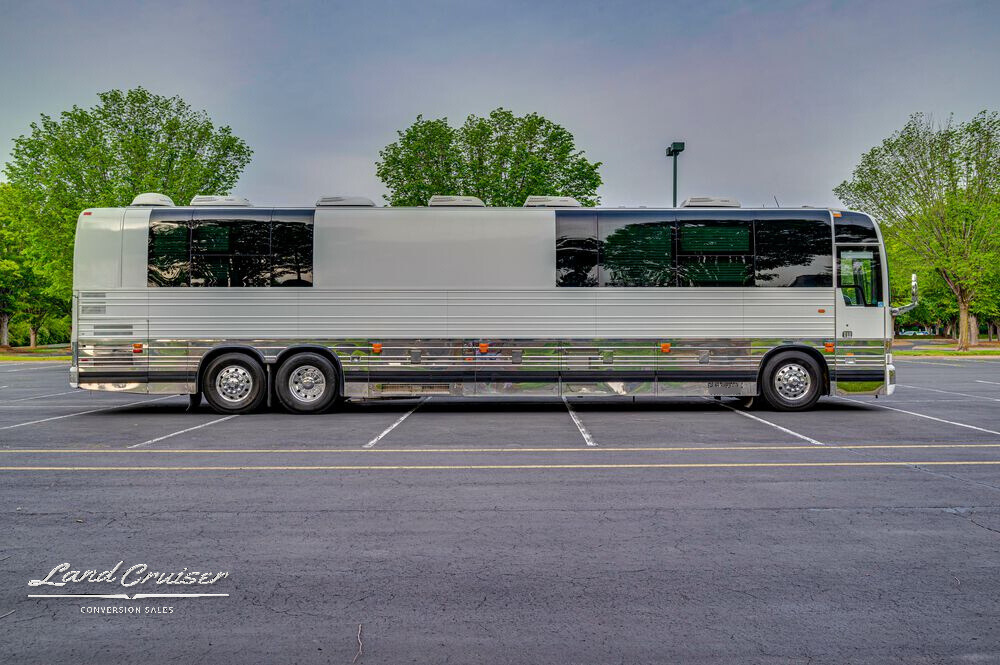 Driver-side full exterior view of Prevost Shogun entertainer coach with slide extended