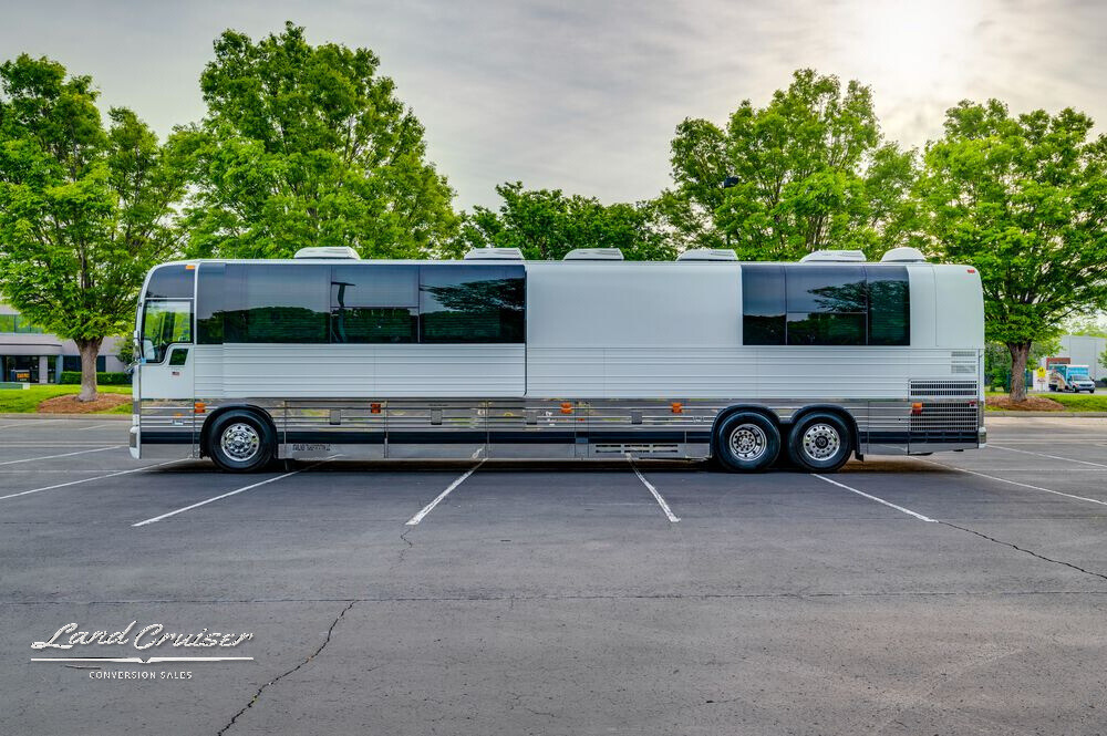 Passenger-side view of Shogun Prevost entertainer coach with polished aluminum and vented roofline