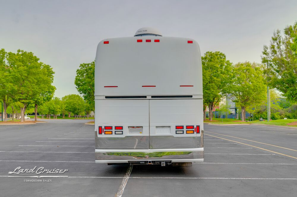 Angled rear exterior of Shogun coach featuring trailer hitch, backup lighting, and full body polish
