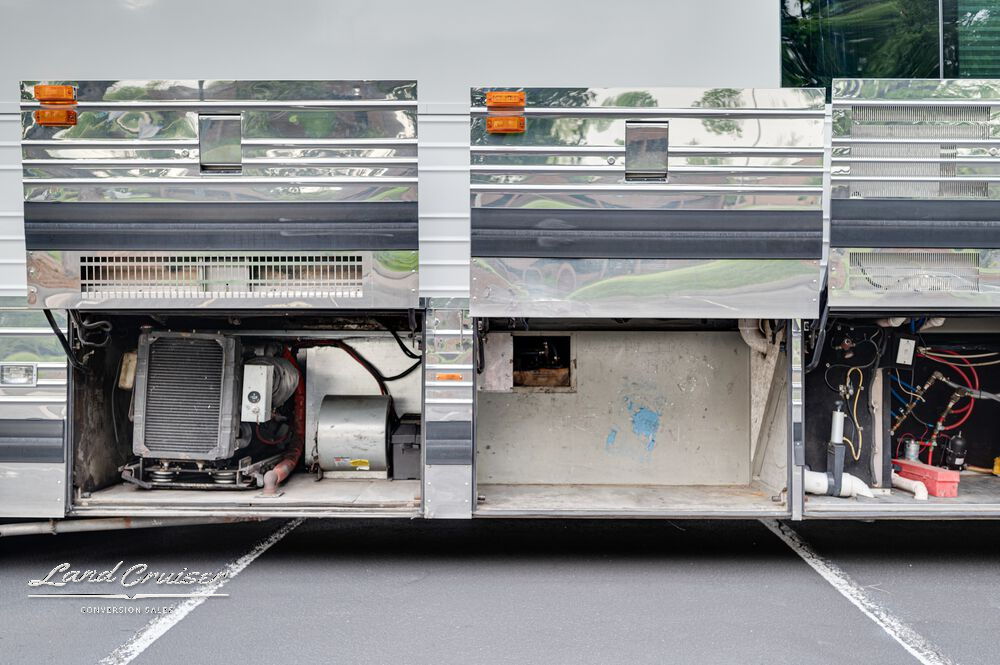 Rear driver-side access showing hoses, electrical inlets, and storage containers