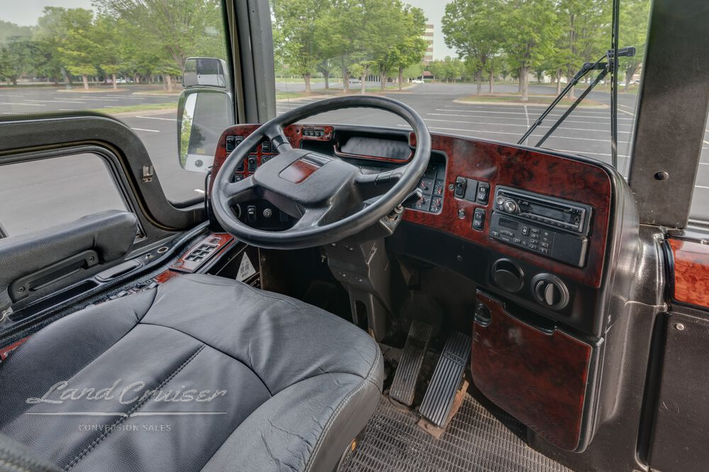 Detailed view of Prevost XLII dashboard with steering controls and woodgrain console finish