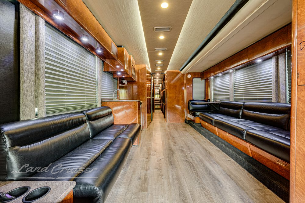 Rearward view of Shogun’s main salon with leather sofas, wood cabinetry, and LED ceiling lights